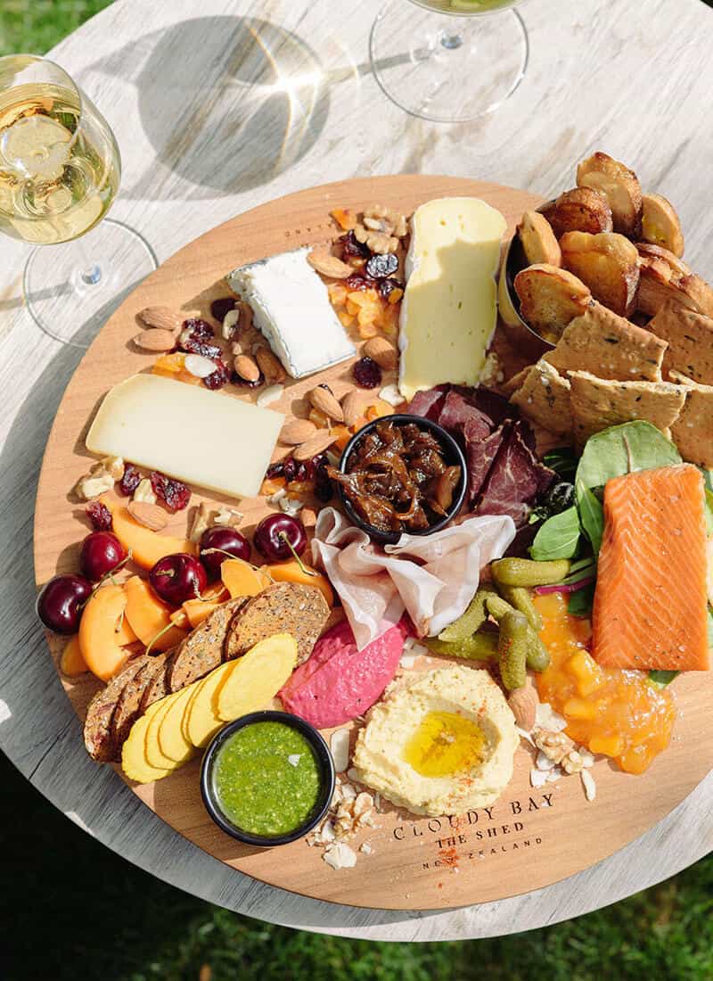 Food platter from Cloudy Bay shed with two glasses of white wine