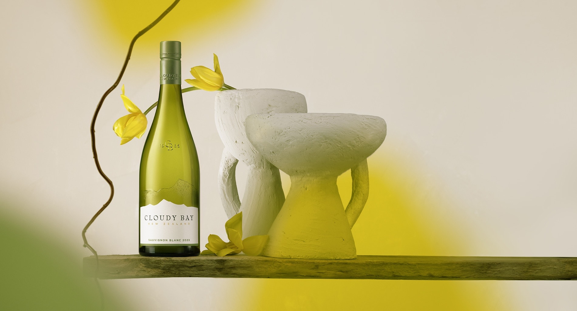 Desktop banner image showing bottle of Sauvignon Blanc 2023 with yellow flowers