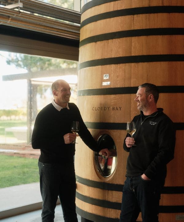 Winemaking Director Nikolai and Daniel Sorrell in front of a barrel