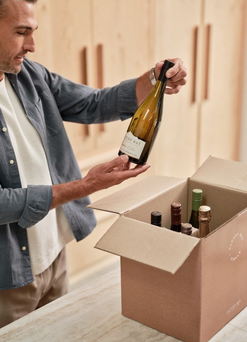 Man opening the wine club shipment