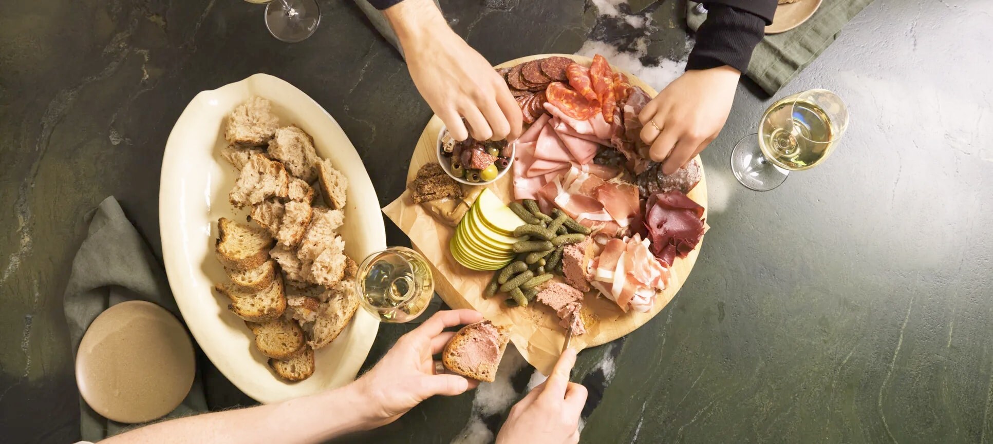people enjoying charcuterie board