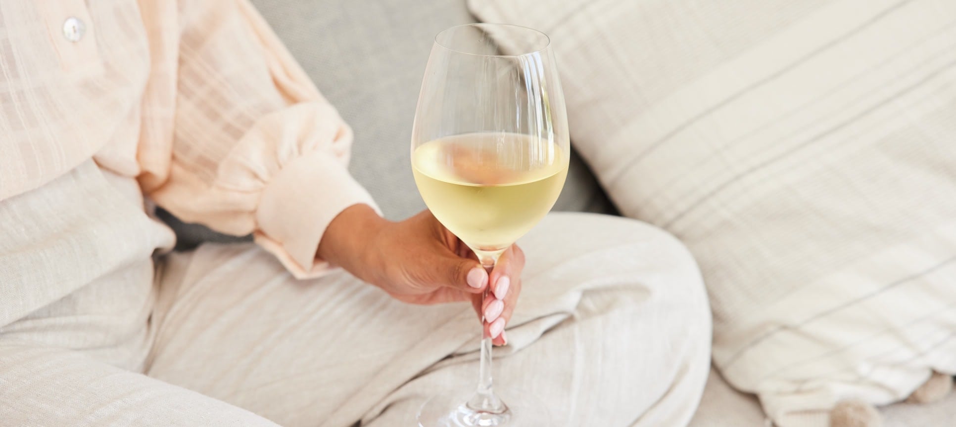 person enjoying glass of wine at home