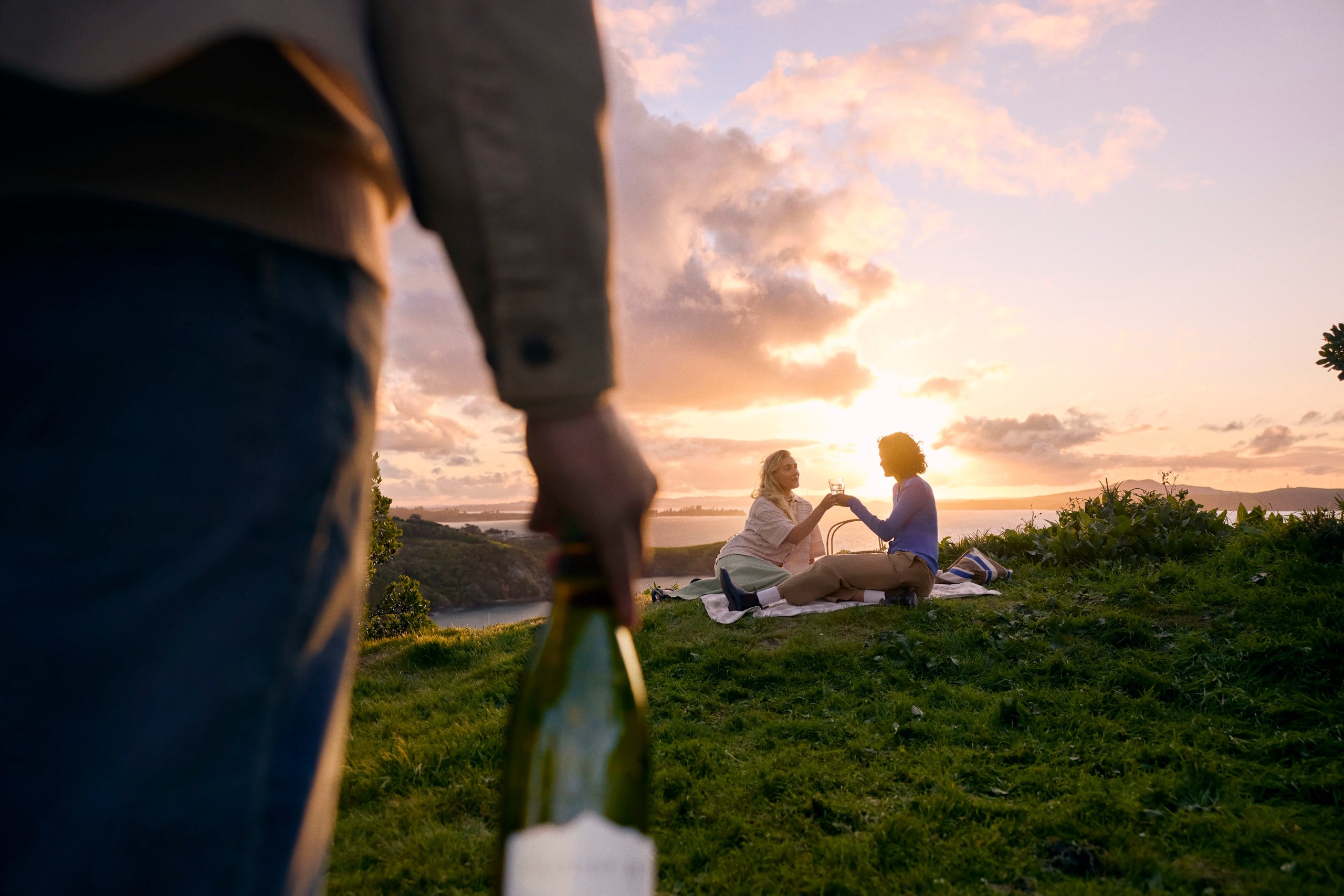 friends enjoying wine at sunset