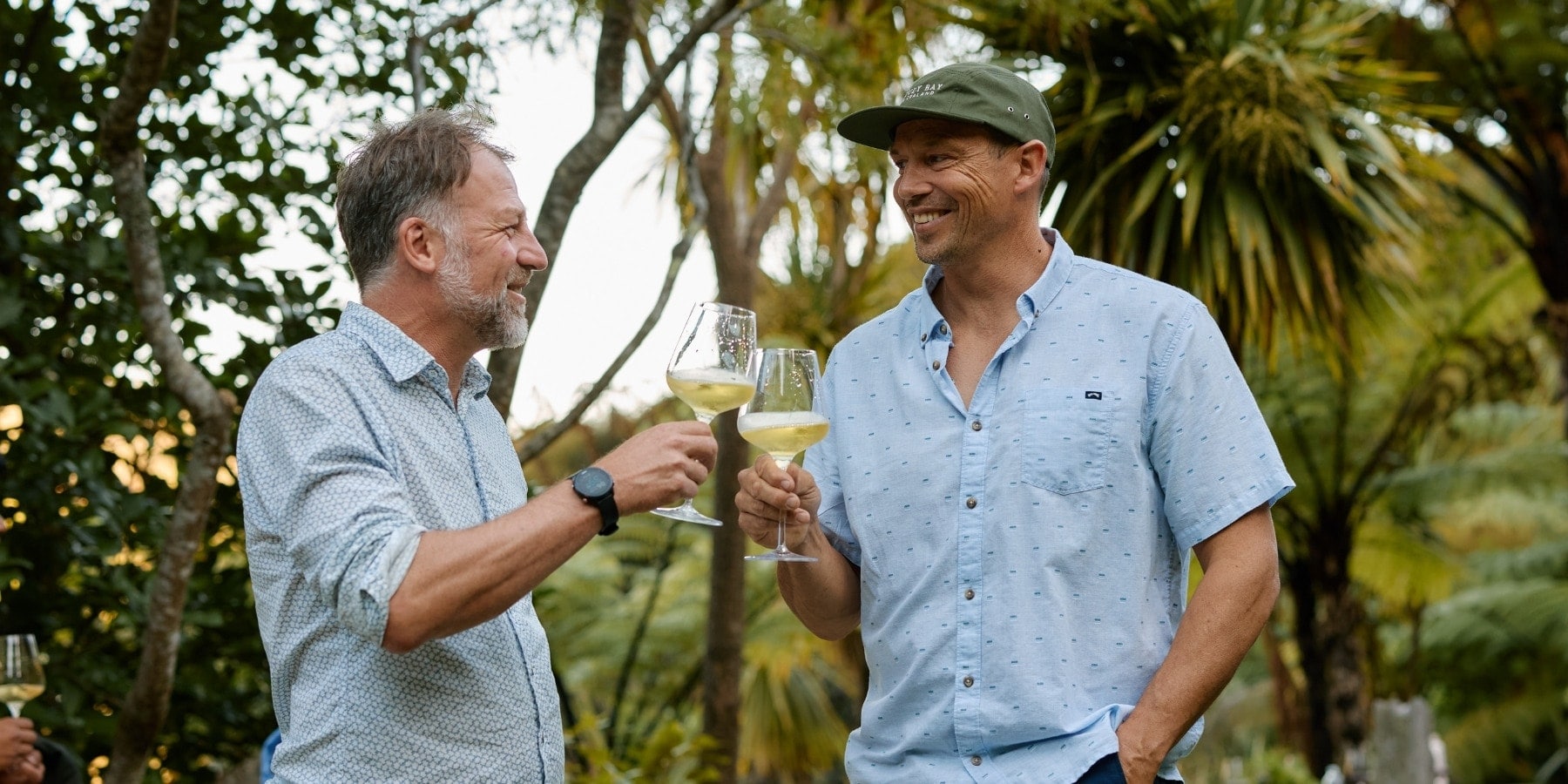 Nikolai St George and Jim White raise their glasses to the end of harvest — a season of hard work, ripe fruit, and well-earned cheers.