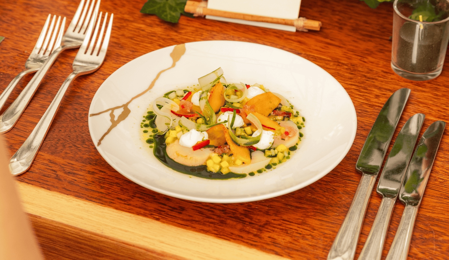 White plate with Scallop Ceviche on a wood table