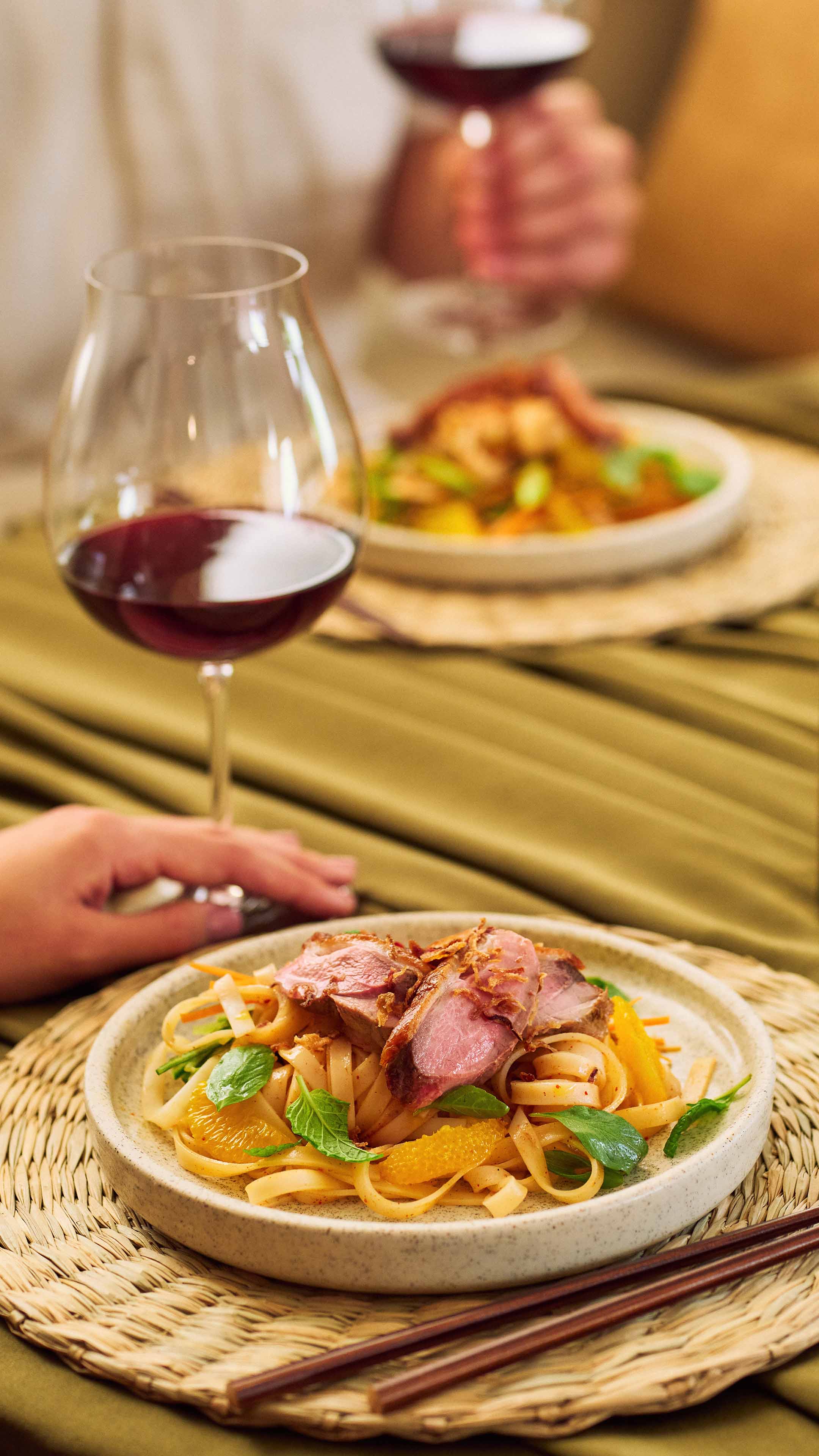 Crispy Duck on noodle salad with glass of Te Wahi