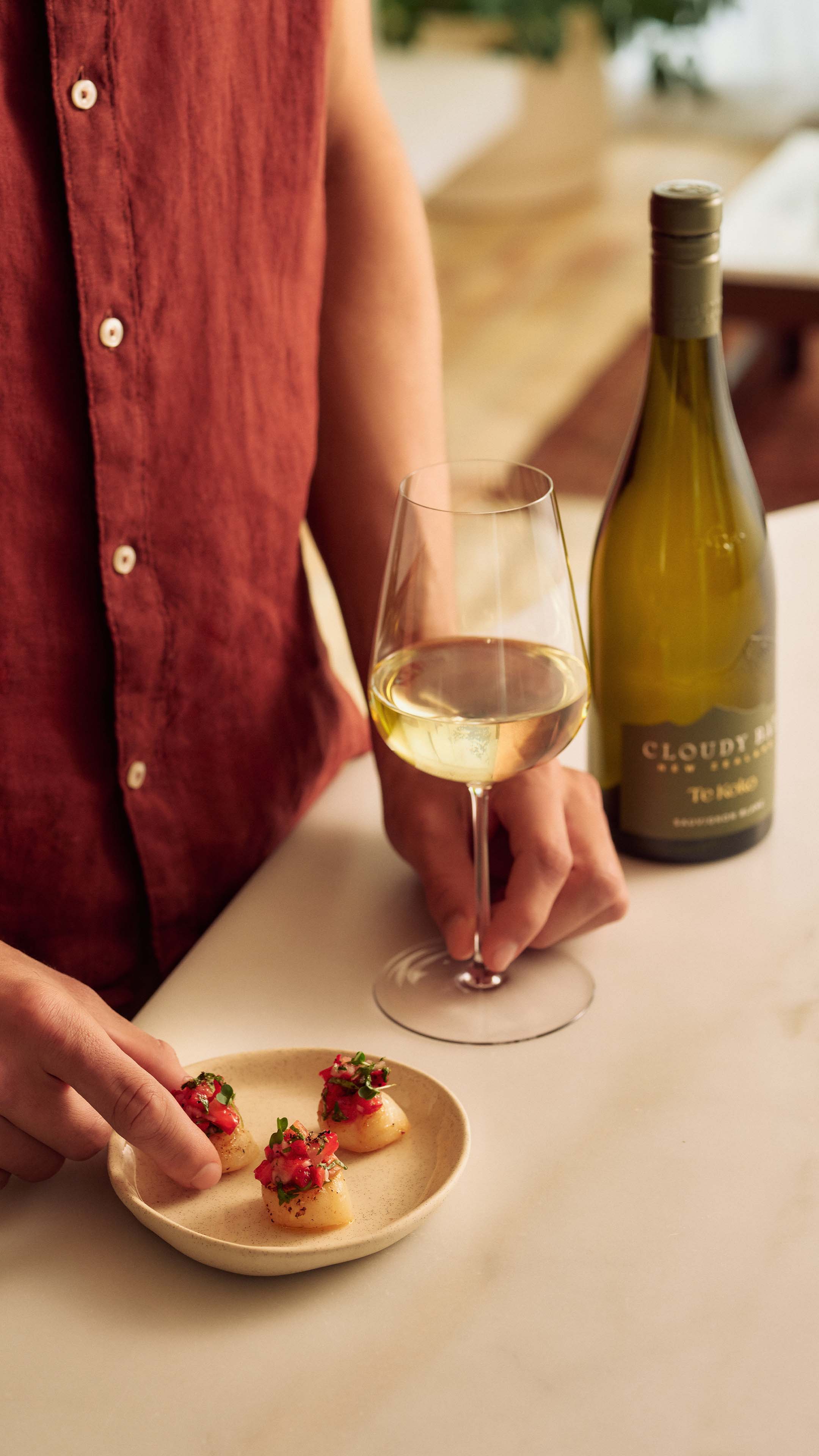 glass and bottle of Te Koko with Scallop Bites
