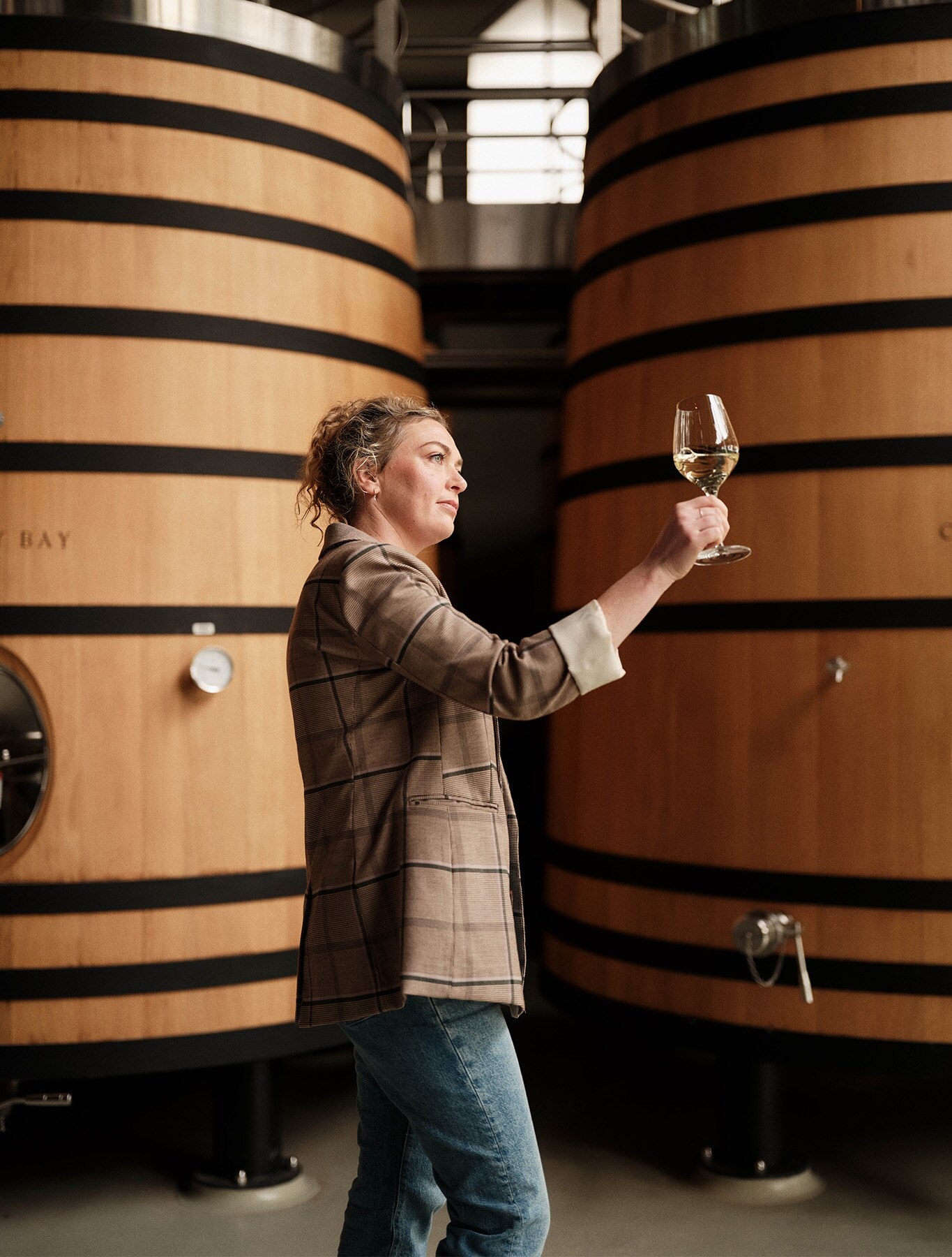 Kelly looking at the wine in a glass