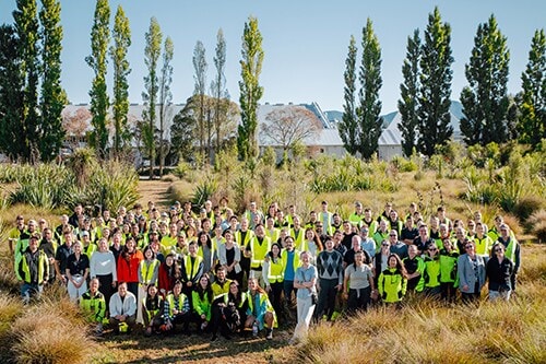 Group photo of Cloudy Bay staff standing in the garden