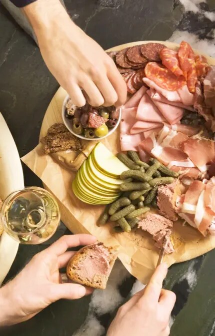 people enjoying charcuterie board