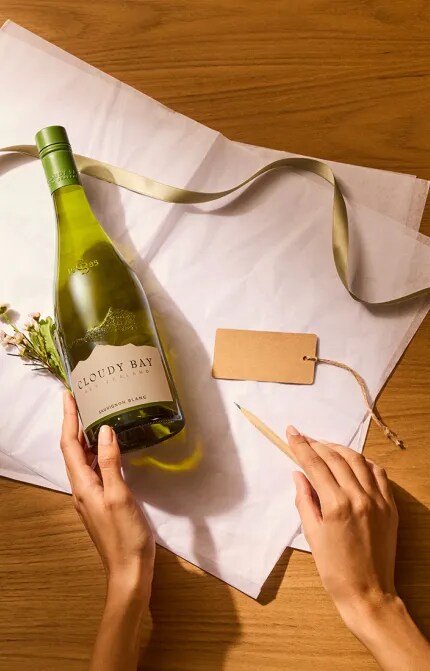 Hands preparing a Sauvignon Blanc Bottle gift