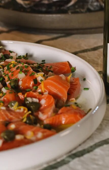 Fish crudo with lemon and a bottle of Cloudy Bay Sauvignon Blanc