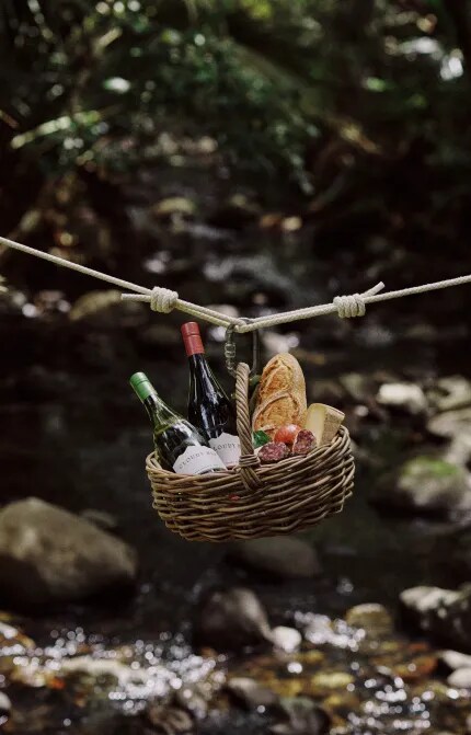 picnic basket on rope over river